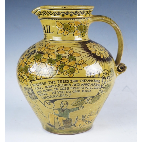 1236 - A 20th century pottery Wassail jug, with incised decoration of figures dancing around an apple tree,... 