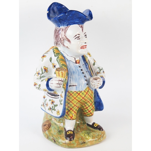 1252 - A 20th century French faience Toby style jug, the standing gentleman in traditional attire with tric... 