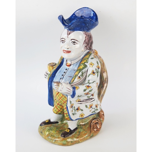 1252 - A 20th century French faience Toby style jug, the standing gentleman in traditional attire with tric... 