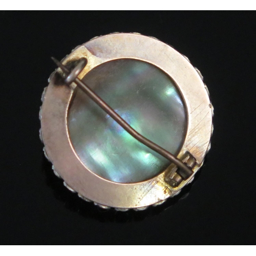 128 - A Vintage Opalescent Glass and White Stone Moon Brooch, moulded with a smiling face and in an unmark... 