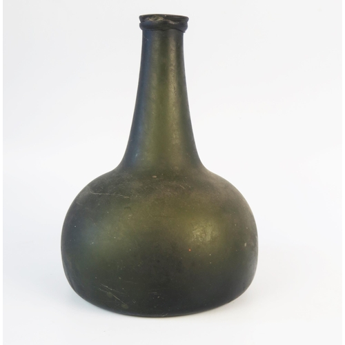 1281 - An early 18th century green glass wine bottle, of onion shape, with moulded neck ring, 19cm high.