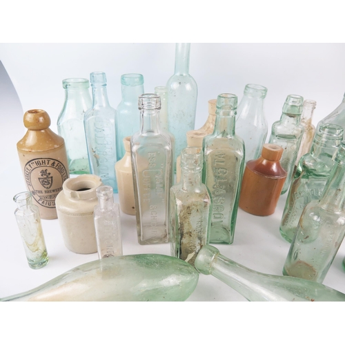 1293 - A collection of assorted glass bottles, including wine bottle, Cod Liver Oil bottle, stoneware bottl... 