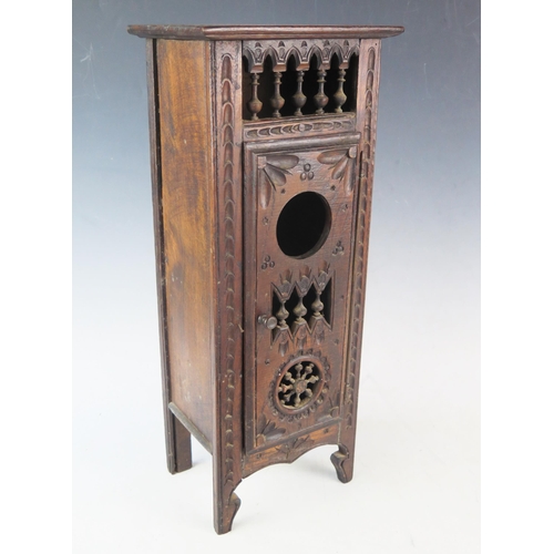 1304 - A Brittany furniture miniature armoire watch stand, with galleried frieze, with panelled door raised... 