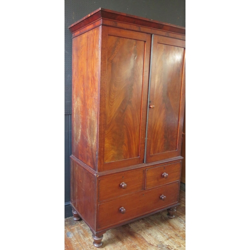 1307 - A 19th century mahogany linen press, with moulded cornice above a pair of plain field cupboard doors... 