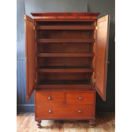 1307 - A 19th century mahogany linen press, with moulded cornice above a pair of plain field cupboard doors... 