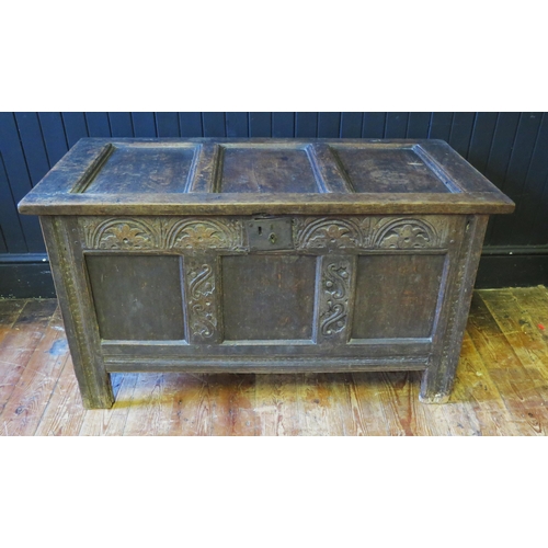 1308 - An 18th Century oak coffer, of panelled construction with lunette carved frieze, raised on block sup... 