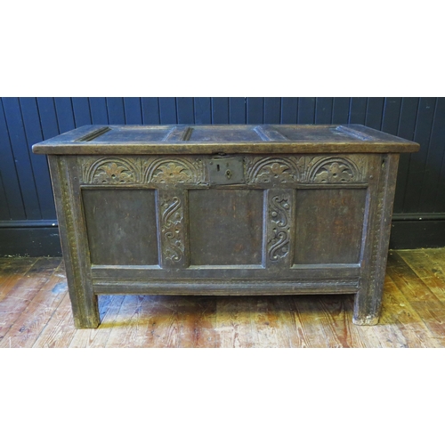 1308 - An 18th Century oak coffer, of panelled construction with lunette carved frieze, raised on block sup... 