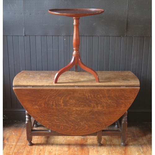 1309 - A late 18th century oak dining table, the oval top with two drop leaves, on turned and block legs wi... 