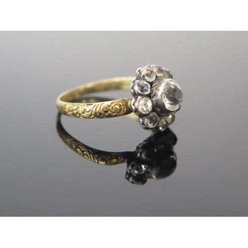 131 - A Georgian Foil Backed White Paste Cluster Ring in an unmarked yellow and white metal setting with c... 