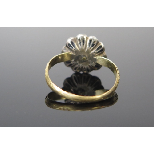 131 - A Georgian Foil Backed White Paste Cluster Ring in an unmarked yellow and white metal setting with c... 