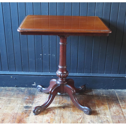 1311 - A Victorian mahogany occasional table with a moulded edge, raised on a turned and reeded column on s... 