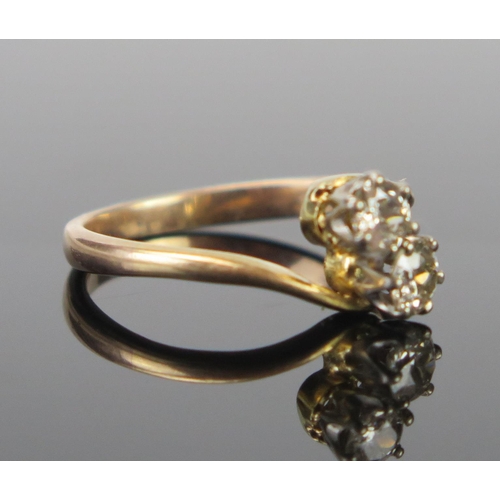 140 - A Twin Diamond Crossover Ring in an unmarked high carat gold setting, EDW .5ct, size M.5, 2.7g