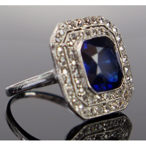 168 - An Art Deco Sapphire and Diamond Ring in an unmarked white metal setting, the central c. 9.8x9.3mm, ... 