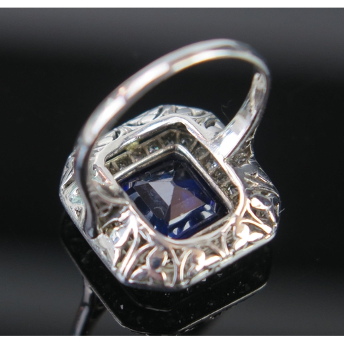 168 - An Art Deco Sapphire and Diamond Ring in an unmarked white metal setting, the central c. 9.8x9.3mm, ... 