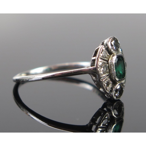 170 - An Antique Deco Emerald and Diamond Ring, the central c. 4.3x3.8mm stone in a rub over setting and w... 