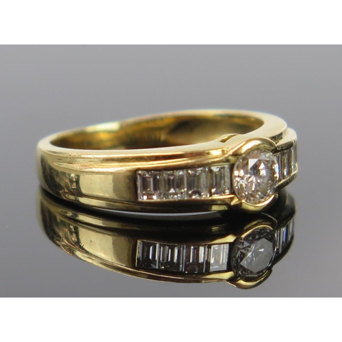 184 - An 18ct Gold and Diamond Ring, the central brilliant round cut estimated at .28ct and with four bagu... 