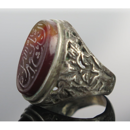 188 - A Persian(?) Islamic White Metal Seal Ring set with agate engraved with script, size P.25, 9.5g