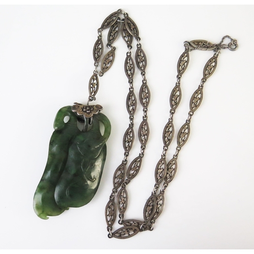 199 - A Chinese Jadeite and Silver Pendant and Chain,  carved as two aubergines / eggplants, on a lozenge ... 