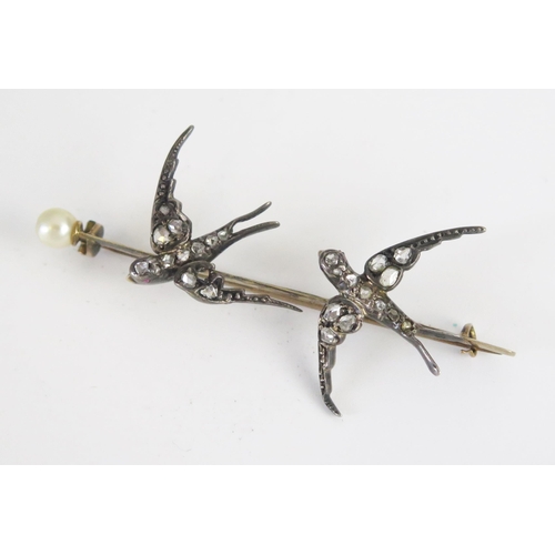 21 - An Antique Rose Cut Diamond and untested Pearl Twin Swallow Brooch with ruby set eyes in an unmarked... 
