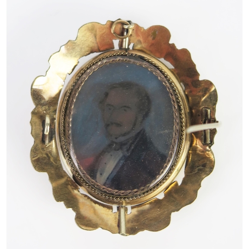 265 - A Large Victorian Gilt Memorial Swivel Brooch decorated with a miniature portrait of a gentleman and... 