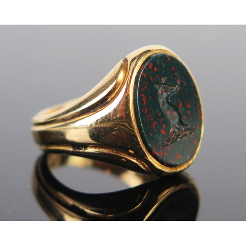 286 - An 18ct Gold and Bloodstone Signet Ring decorated with a dogs head in profile, London 1935, size L.2... 