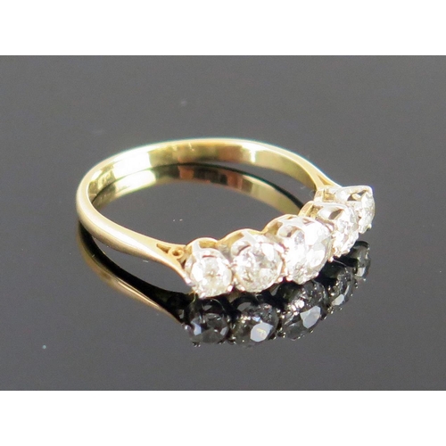 3 - A Diamond Five Stone Ring in an 18ct gold and platinum setting, central stone 5mm diam., size P.5, 2... 