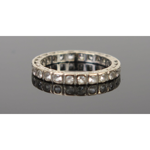 302 - An 18ct Gold and White Stone Eternity Ring, size M.5, 2.9g