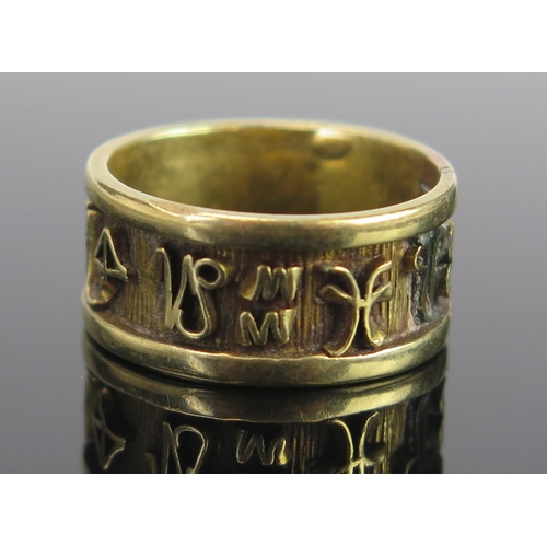 37 - An Unusual Unmarked Gold Band decorated with a band of continuous symbols, 9mm wide, size O, 5.6g