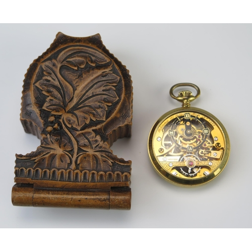 439 - A Modern Hebdomas Gold Plated Pocket Watch in old carved tree stand