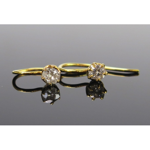 45 - A Pair of Victorian Diamond Solitaire Earrings, the old cut stones c. 4-4.5mm and in an unmarked gol... 