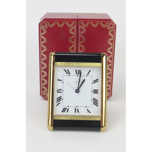 467 - A Boxed Cartier Quartz Easel Back Bedside Clock with alarm in a polished and brushed brass case with... 