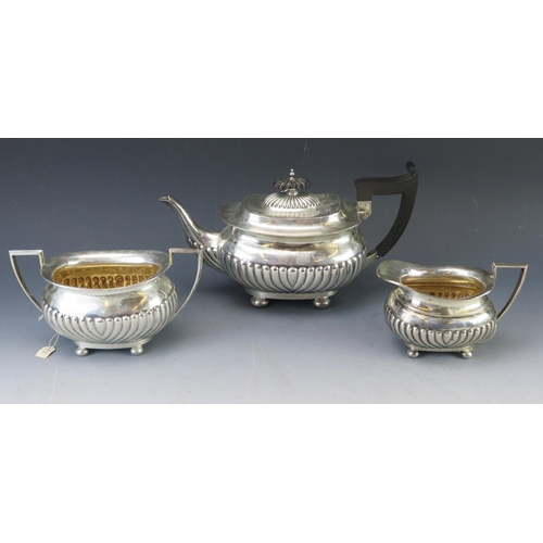 500 - A matched silver three-piece tea service, maker Walker and Hall, Sheffield, 1896 and 1904, of barge-... 