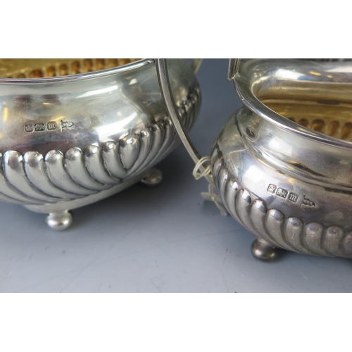 500 - A matched silver three-piece tea service, maker Walker and Hall, Sheffield, 1896 and 1904, of barge-... 