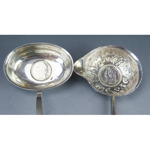 532 - A Georgian silver toddy ladle, with foliate and scroll decoration inset with coin, mounted on a bali... 