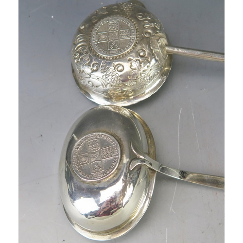 532 - A Georgian silver toddy ladle, with foliate and scroll decoration inset with coin, mounted on a bali... 