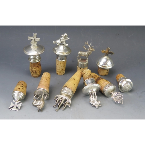 533 - A collection of English and continental silver and plated bottle stoppers, modelled as galleon, wind... 