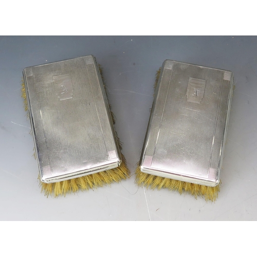 542 - A pair of 20th century silver backed brushes, marks worn, initialled with engine turned decoration.