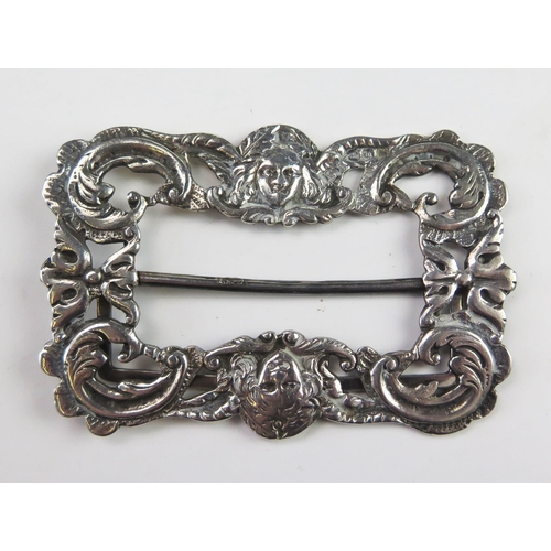 595 - A Victorian silver buckle, maker Henry Matthews, Birmingham, 1896, with winged cherub faces and scro... 