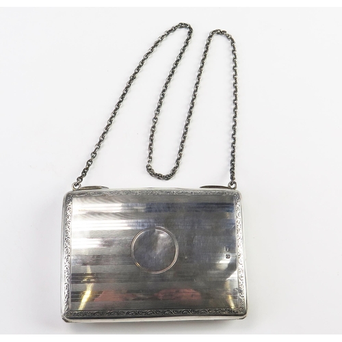 604 - A George V silver purse, maker George Unite, Birmingham, 1913, with engine turned decoration and sil... 