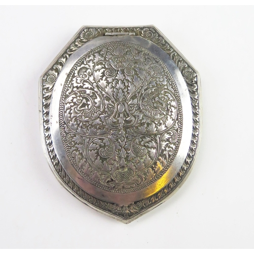 606 - An Indo-Persian silver compact of shield-shaped outline, the lid interior with mirror plate 9.5cm lo... 