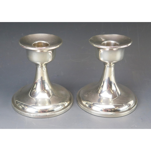 609 - A pair of George V silver candlesticks, maker Charles Perry & Co, Chester, 1926, with urn-shaped sco... 