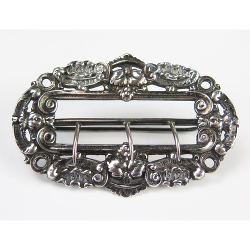 622 - A Victorian silver buckle, maker Thomas Bradbury & Sons, London, 1888, with pierced decoration of sc... 