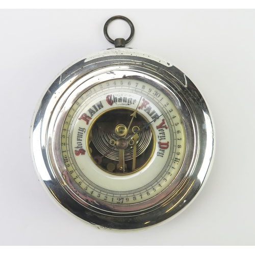 629 - An early 20th century silver cased aneroid barometer, all marks worn, London, with circular ivorine ... 