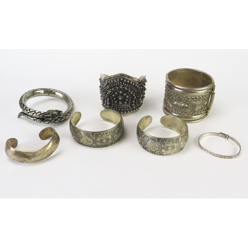 631 - A collection of Asian white metal bangles, amulets and a christening bangle, 380gms, 12.23ozs