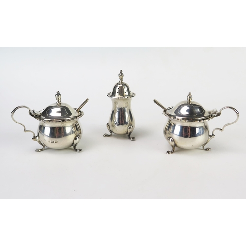 637 - A matched three-piece silver condiment set, maker Adie Brothers, Birmingham, various dates, with blu... 