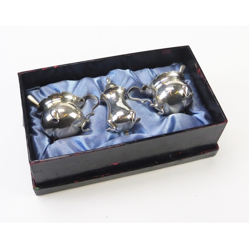 637 - A matched three-piece silver condiment set, maker Adie Brothers, Birmingham, various dates, with blu... 