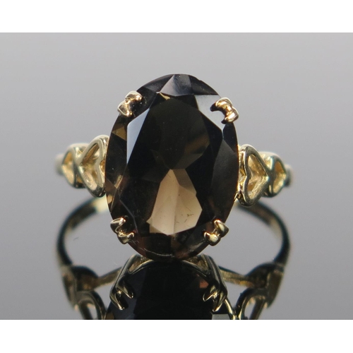 66 - A 9ct Gold and Smoky Quartz Dress Ring, the 14x10mm stone in a claw setting, full Birmingham hallmar... 