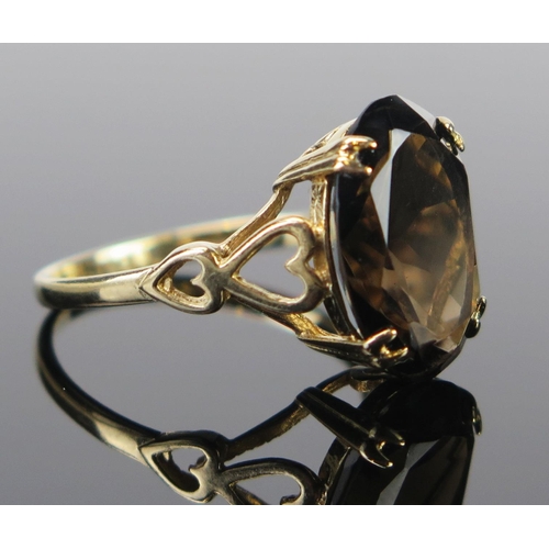 66 - A 9ct Gold and Smoky Quartz Dress Ring, the 14x10mm stone in a claw setting, full Birmingham hallmar... 