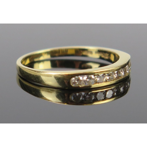 69 - An 18ct Gold and Diamond Half eternity Ring, shank stamped 33PTS and with full London hallmarks, siz... 