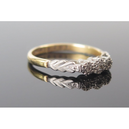 75 - An 18ct Gold and Diamond Three Stone Ring, illusion set in platinum, size P.5, 2.9g. Sold in heart s... 